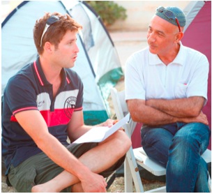 Haim Bar Yaakov (right) discusses housing problems with a fellow activist.